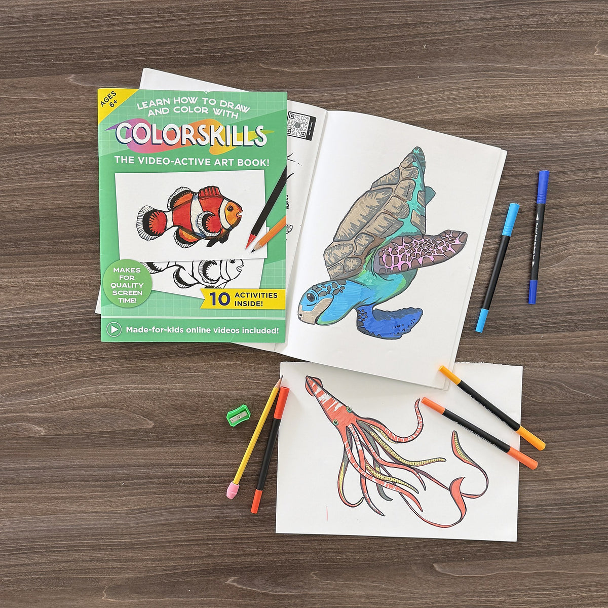 COLORSKILLS Ocean Animals drawing book with a finished colored sea turtle and squid and markers